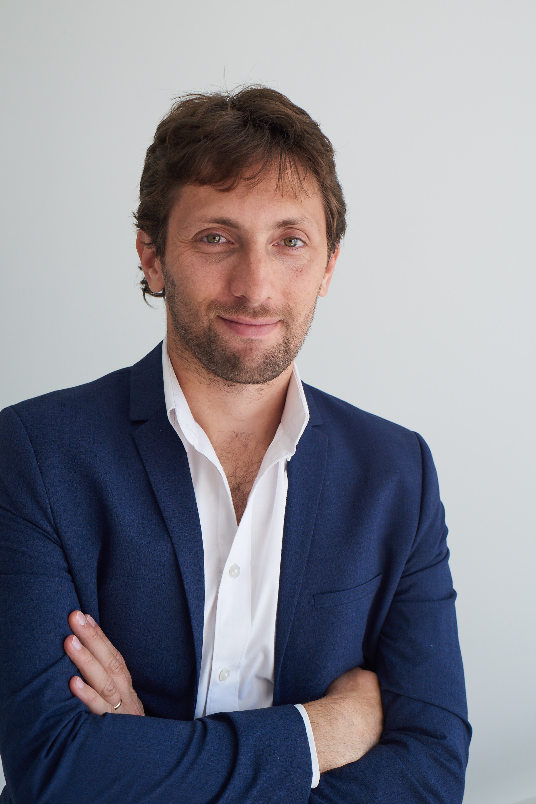 Gaston Krasny, tech entrepreneur and former CTO of SeSocio, in a navy blazer — official press portrait