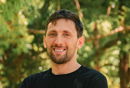 Gaston Krasny smiling outdoors — casual press portrait of the Argentine tech entrepreneur
